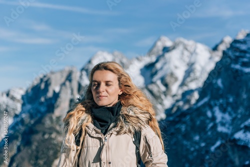 Female standing in front of snow covered mountain