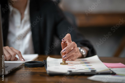 Businesswoman stamping on documents approve business successful.