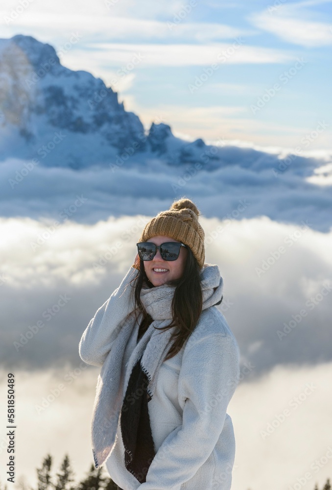 Caucasian woman wearing warm cloth standing in front of snow covered mountain Caucasian woman wearing warm cloth standing in front of snow covered mountain