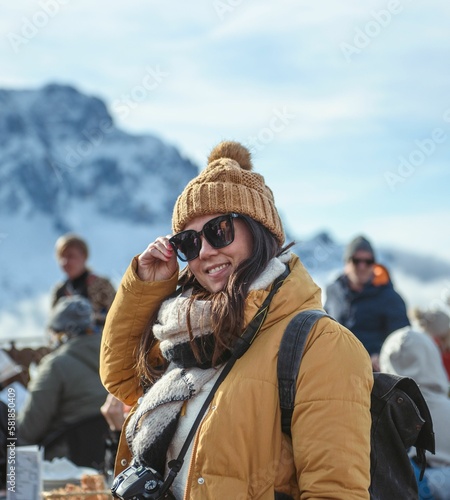 Close-up shot of a young girl in winter clothes standing in ski resort at Monte Lussari in Italy