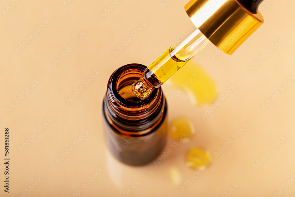 Laboratory studies. Dropper with yellow liquid was taken out of glass cosmetic amber bottle. Pipette with solution, essence, serum, emulsion. Natural organic cosmetics Laboratory studies. Dropper with yellow liquid was taken out of glass cosmetic amber bottle. Pipette with solution, essence, serum, emulsion. Natural organic cosmetics