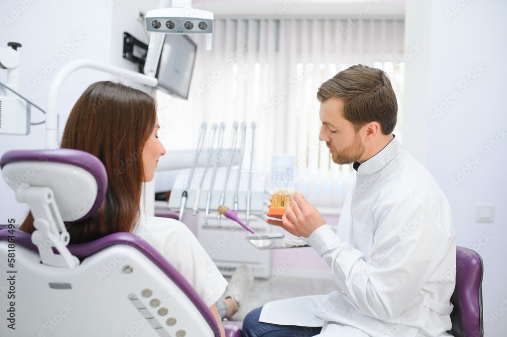 The concept of diagnosis and treatment of tooth disease. Doctor shows a ...