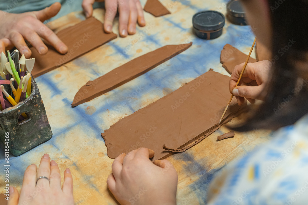 Close up of human hands making a clay mug. Pottery teaching class. Potter makes dishes from clay, ceramics. Close up of human hands making a clay mug. Pottery teaching class. Potter makes dishes from clay, ceramics.