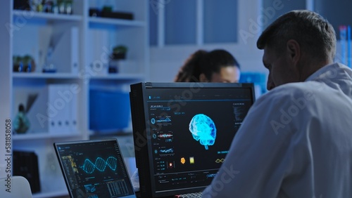 Medical laboratory scientist studying patient's brain mri on computer, diagnostics photo