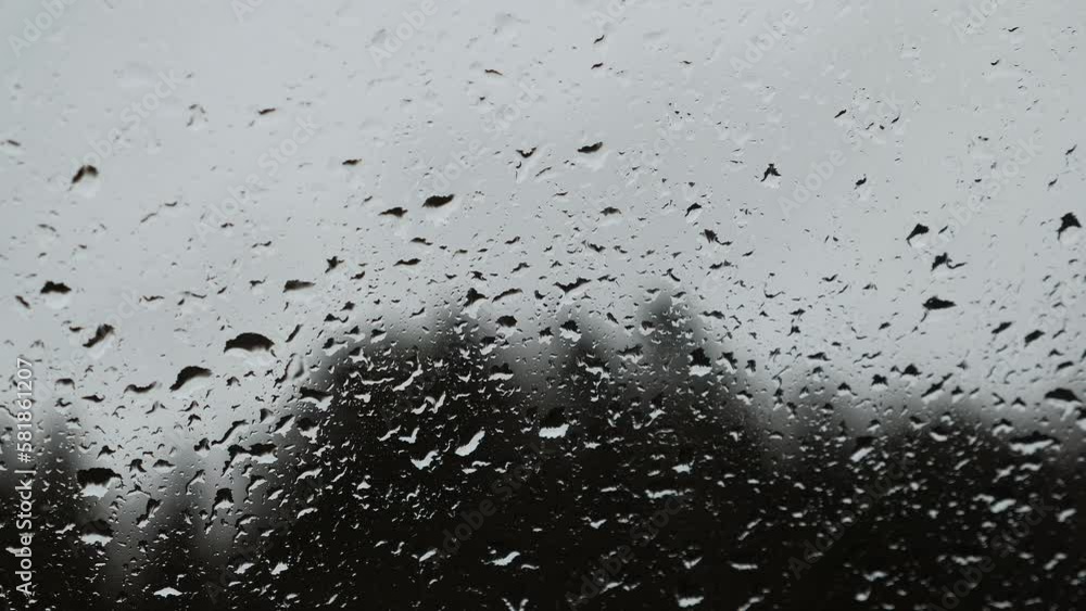 Autumn rainy weather. Raindrops on window glass at cloudy grey day, close up Autumn rainy weather. Raindrops on window glass at cloudy grey day, close up