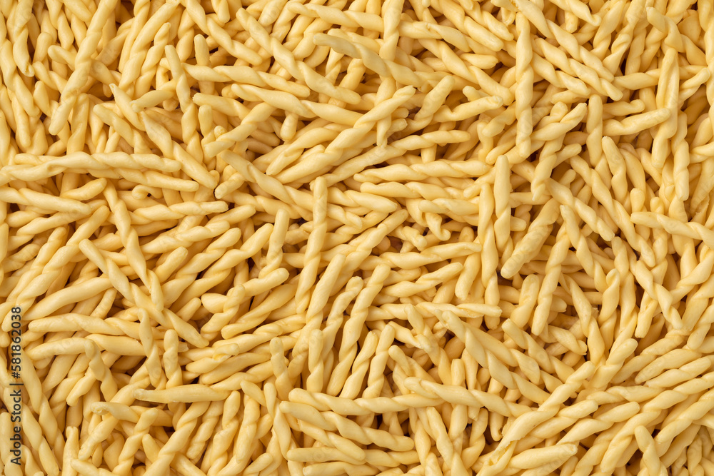 Dried Italian trofie pasta close up full frame as background Dried Italian trofie pasta close up full frame as background