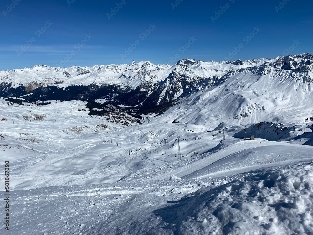 Snowy mountains in Switzerland. Panoramic view over the mountains during winter. Ski area Arosa, Lenzerheide in Switzerland. 