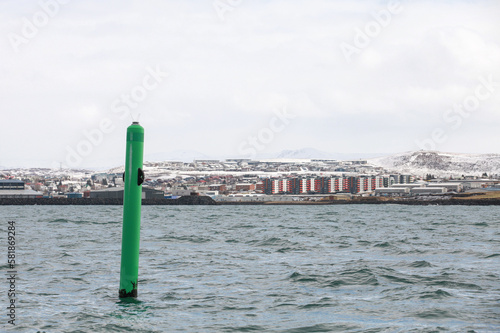Port hand green spar buoy with light on top. Navigation equipment