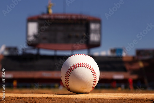 Photography A white leather baseball lying on top of the pitcher's mound