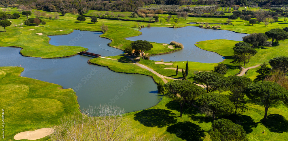 Aerial view of an empty golf course with many lakes and ponds. There is no one in the sports club. Sports concept. Aerial view of an empty golf course with many lakes and ponds. There is no one in the sports club. Sports concept.