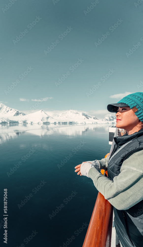 Female Tourist On Luxury Antarctica Cruise Ship Looking Out At The Stunning Scenic Arctic Landscape