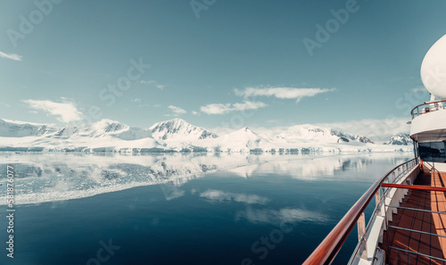 Panorama from Cruise Ship showing Snow Glacier Covered Mountains Reflecting in the Still Arctic Water of Antarctica