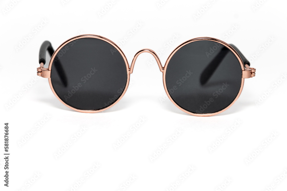 Round sunglasses in a gold frame close-up on a white background