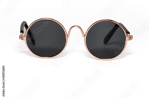Round sunglasses in a gold frame close-up on a white background