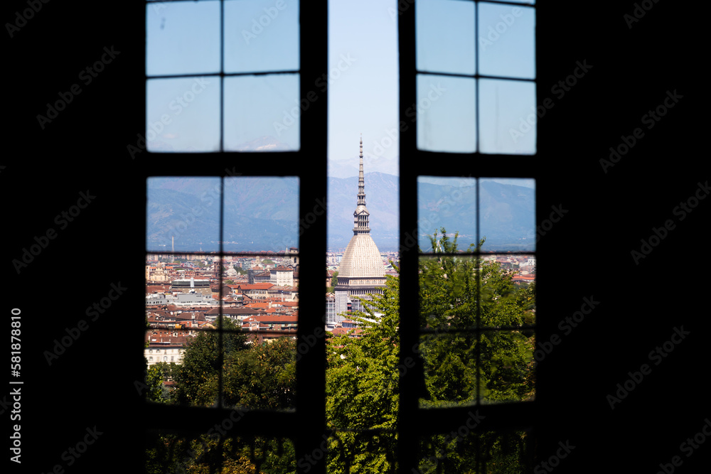 Fototapeta premium Turin - Italy - Urban skyline with Mole Antonelliana building, blue sky and Alps mountains.