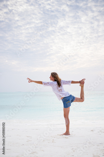 woman doing yoga by the sea pastel colors