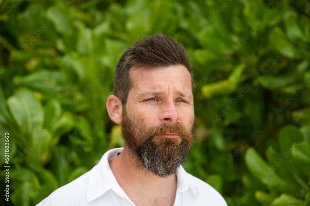 handsome man portrait and lush tropical greenery handsome man portrait and lush tropical greenery