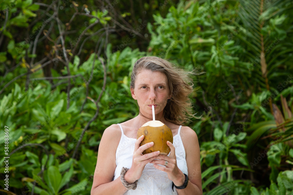 woman portrait and lush tropical greenery