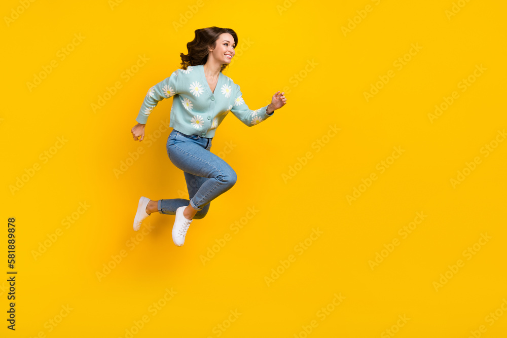 Full length photo of excited pretty lady dressed teal cardigan jumping high running fast emtpy space isolated yellow color background