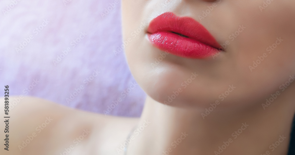 Fototapeta premium Bright red women's lips close-up.