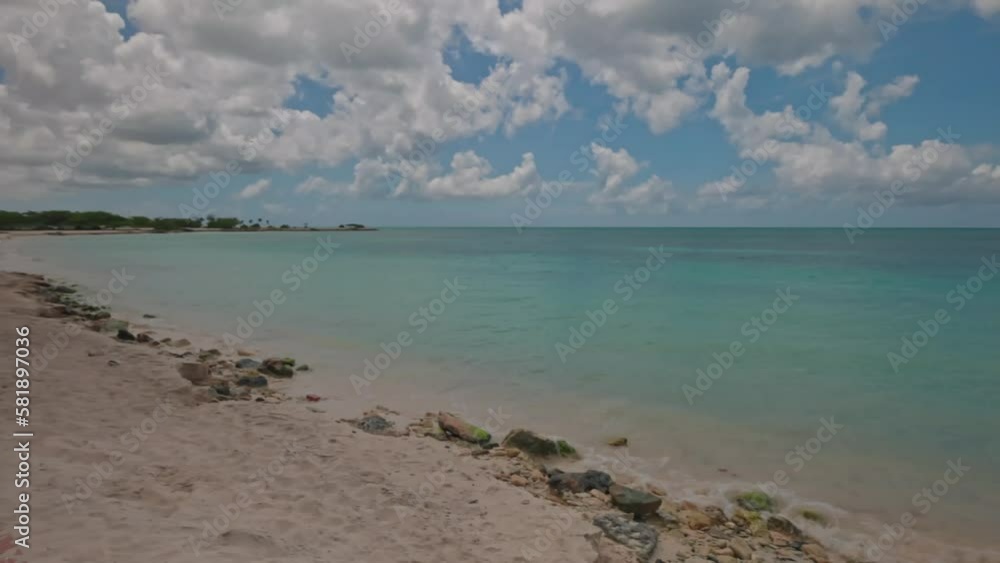 Beautiful view of sandy Eagle beach of Atlantic Ocean with incoming wave on shore turquoise water. Aruba. Beautiful view of sandy Eagle beach of Atlantic Ocean with incoming wave on shore turquoise water. Aruba.