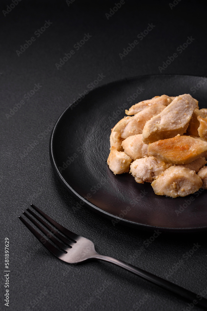 Delicious chicken slices baked with spices and herbs on a round ceramic plate Delicious chicken slices baked with spices and herbs on a round ceramic plate