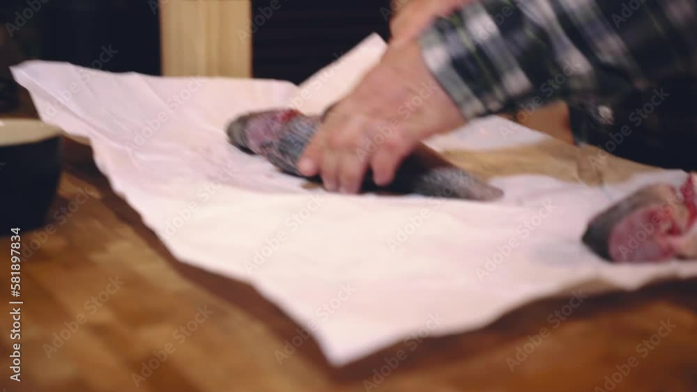 Man cooking fish in the kitchen Man cooking fish in the kitchen