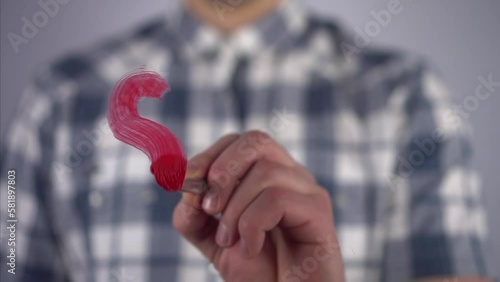 A young man draws on the glass the word sex photo