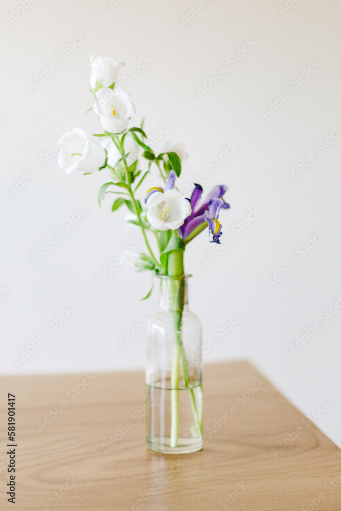 Flowers in a glass vase on a table Flowers in a glass vase on a table