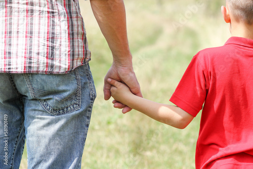 A Hands of happy child and parent on nature in the park family concept © Kostia