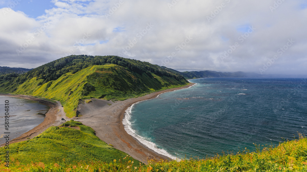 Cape Evstafiya in the Sea of Okhotsk, Russia. Picturesque hills, with bright herbs and blue sea on Sakhalin. Cape Evstafiya in the Sea of Okhotsk, Russia. Picturesque hills, with bright herbs and blue sea on Sakhalin.