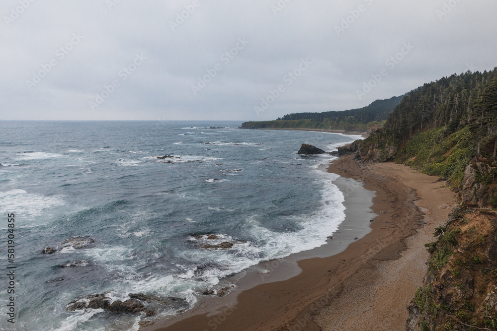 Picturesque Cape Velikan on the shore of the Sea of Okhotsk in the Far East of Russia, Sakhalin Island. Picturesque coastal cliffs and the sea. Picturesque Cape Velikan on the shore of the Sea of Okhotsk in the Far East of Russia, Sakhalin Island. Picturesque coastal cliffs and the sea.