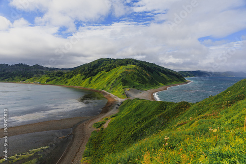 Cape Evstafiya in the Sea of ​​Okhotsk, Russia. Picturesque hills, with bright herbs and blue sea on Sakhalin.