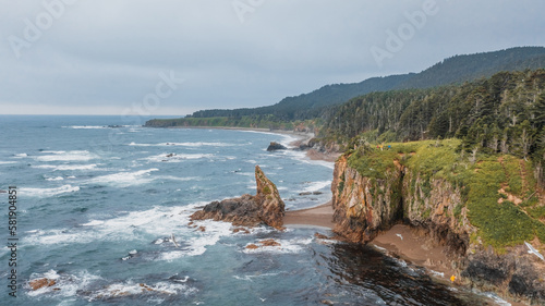 Picturesque Cape Velikan on the shore of the Sea of ​​Okhotsk in the Far East of Russia, Sakhalin Island. Picturesque coastal cliffs and the sea.