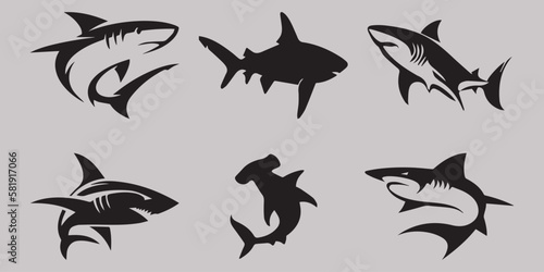 black shark icons on a gray background © Dima