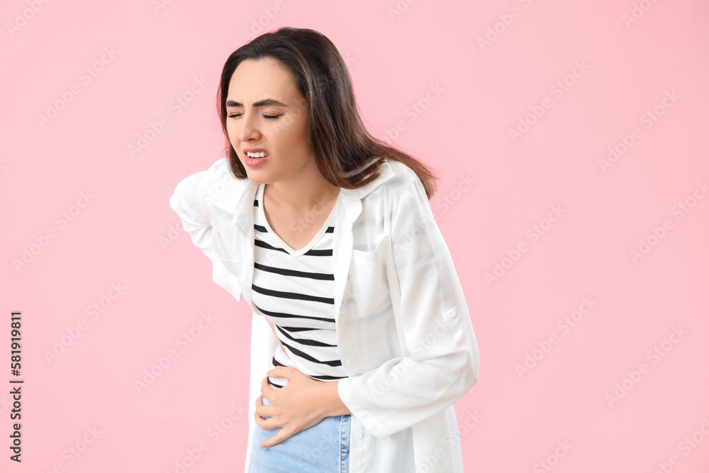 Young woman with appendicitis on pink background Young woman with appendicitis on pink background
