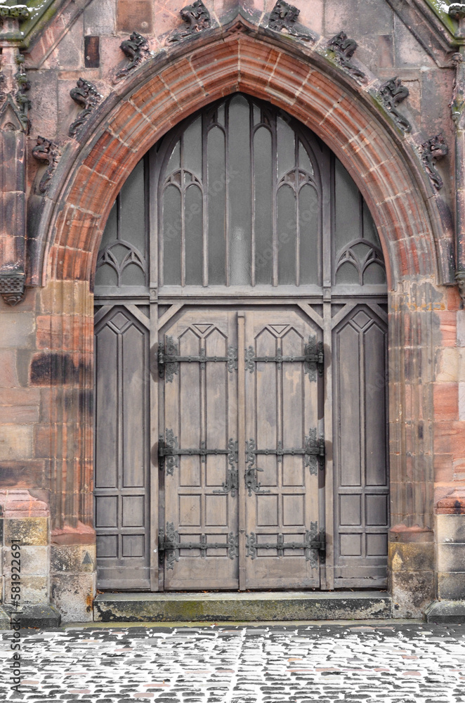 View of old Gothic building with wooden door