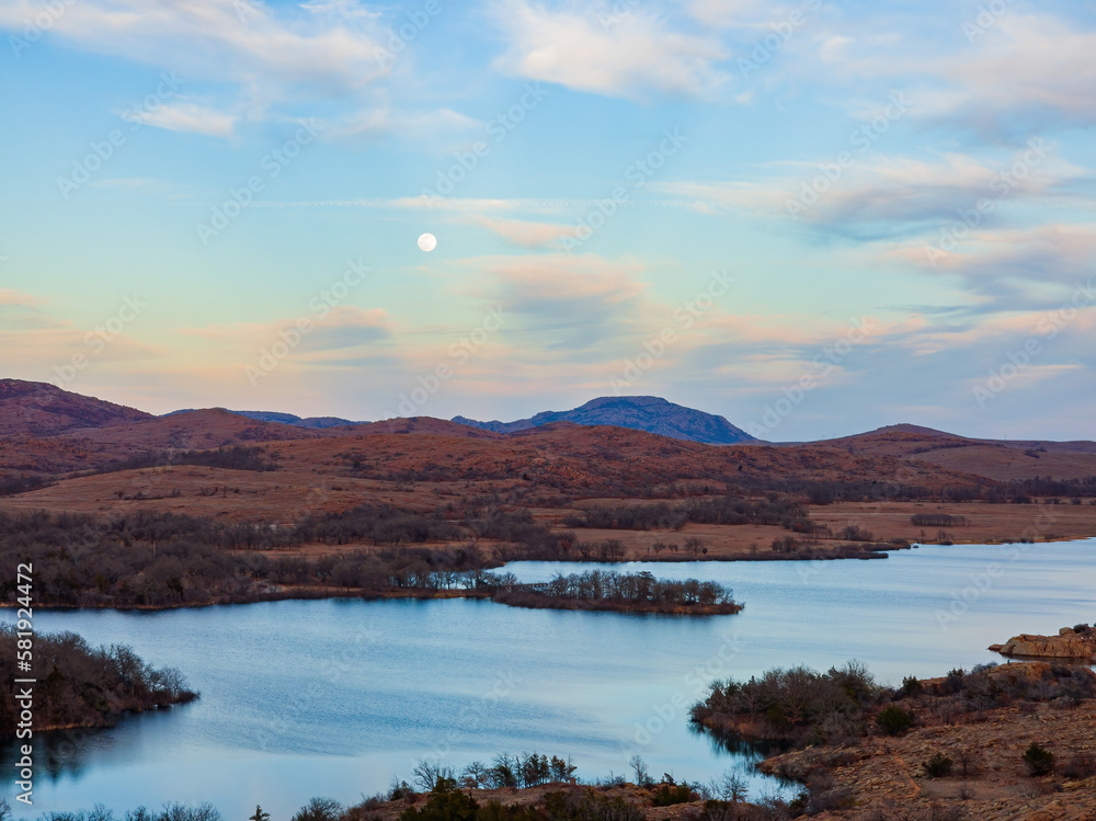 Sunset landscape with a full moon in Wichita Mountains National Wildlife Refuge