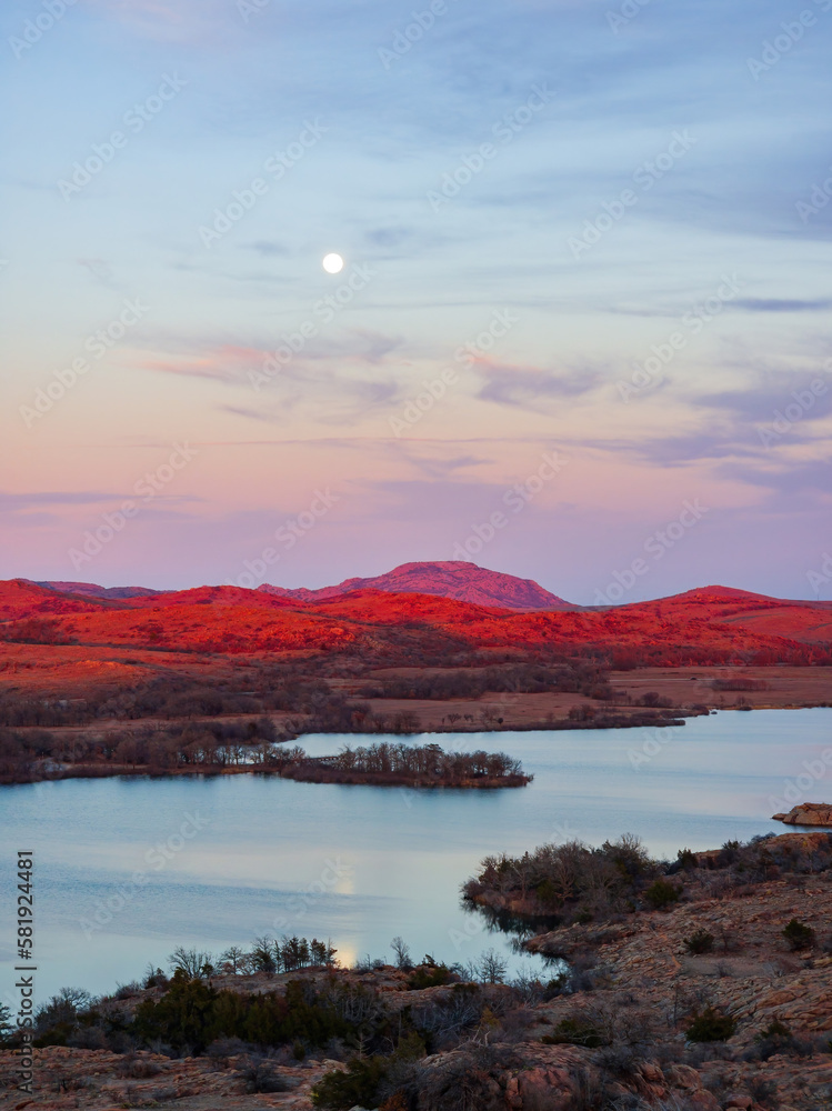 Sunset landscape with a full moon in Wichita Mountains National Wildlife Refuge