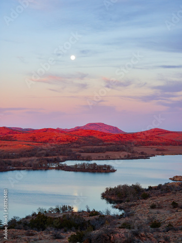 Sunset landscape with a full moon in Wichita Mountains National Wildlife Refuge