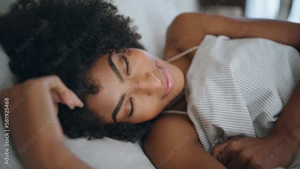 Happy lady wakeup bedroom portrait. African woman looking camera lying bed alone Happy lady wakeup bedroom portrait. African woman looking camera lying bed alone