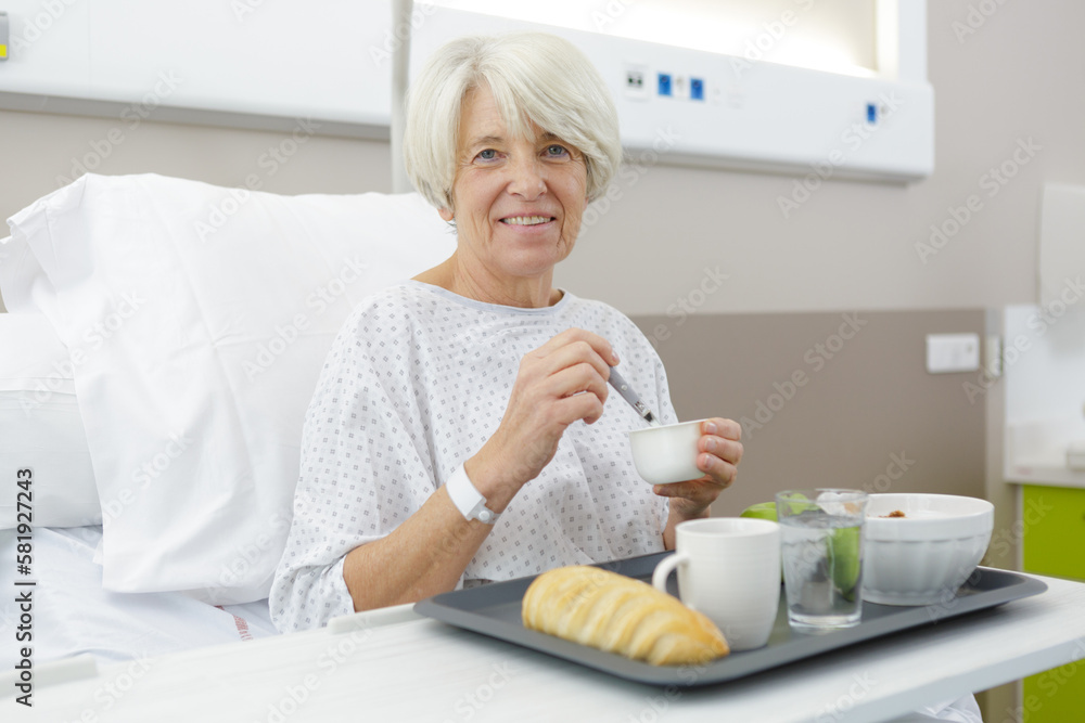 senior woman during healthy breakfast in bed