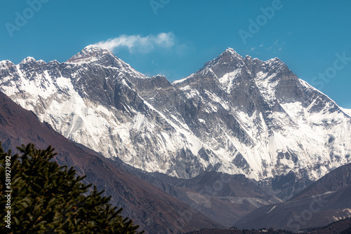 Mount Everest (8850m) with typical cloud, Nuptse (7861m) and Lhotse (8516m) viewed from Tenzing Norgay memorial in Namche bazar photo