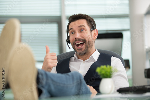 Photography telemarketer man in a office showing ok sign