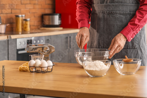 Man making dough for pasta ...