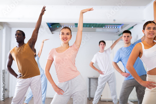 Women and man learning swing steps at dance class