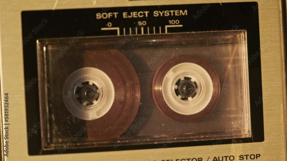 Audiocassette playback in retro tape recorder. Record player playing