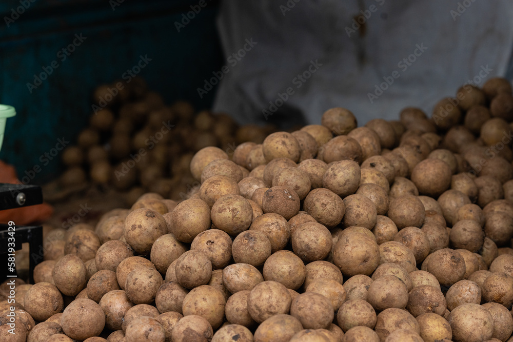A lot of potatoes are piled up at the local farmer's market. The shot was taken in daylight. It shows the vegetable section of the market. A lot of potatoes are piled up at the local farmer's market. The shot was taken in daylight. It shows the vegetable section of the market.