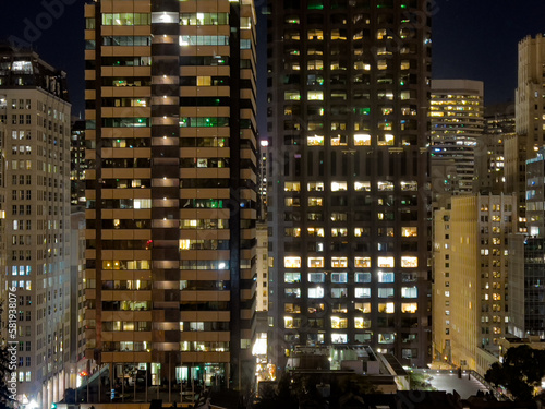 High rise office buildings at night with lights on