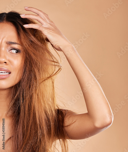 Frizz, messy and woman with a bad hair day isolated on a studio background. Angry, beauty and half of a girl with a frizzy, damaged and tangled hairstyle, stress and frustrated with a salon perm